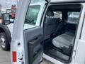 A 2015 Ford F-550 with an open driver's side door revealing an interior view of the rear seating area and black door panel