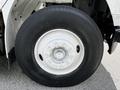 Close-up of a large tire mounted on a 2012 Freightliner M2 106 with visible lug nuts and tread pattern labeled as Azar Energy