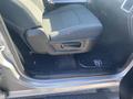 Interior view of a 2021 RAM 1500 showing the driver's side seat and floor mat with a door panel handle and controls visible