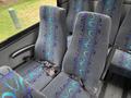 Interior seating of a 2020 Chevrolet Express with gray upholstery featuring colorful wave patterns and safety belts attached to each seat