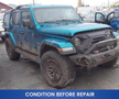 A blue 2020 Jeep Wrangler with a damaged front and muddy tires parked in a lot