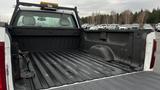 The image shows the bed of a 2013 Chevrolet Silverado 1500 pickup truck with a textured black surface and no visible cargo