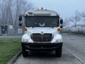 A white 2016 International 4200 bus with a distinct front grille and large windshield featuring multiple lights on top