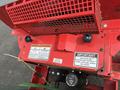 The image shows a red John Deere 1585 Terrain Cut mower with labels and warnings on its engine compartment and important maintenance instructions visible