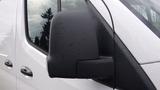 A close-up of the side mirror of a 2024 Mercedes-Benz Sprinter 2500 showing a sleek design with raindrops on its surface