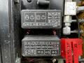 A close-up of a control panel featuring various labeled fuses and circuit diagrams for a 2024 Caterpillar 306