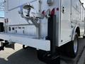 A white 2018 Ford F-550 truck with a towing hitch and diamond plate accents on the rear section