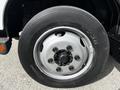Close-up of a wheel mounted on a 2018 Hino 195 showcasing a silver rim and black tire with visible tread patterns and markings