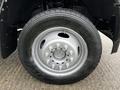 Close-up of a wheel and tire from a 2017 Ford F-550 showcasing a silver rim and black tire with tread patterns visible on the surface