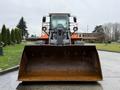 A 2018 Doosan DL300-5 front loader facing forward with a large metal bucket in front and visible hydraulic arms