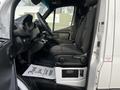 Interior of a 2022 Mercedes-Benz Sprinter showing the driver's seat dashboard and passenger seat with fabric upholstery