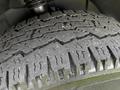 Close-up of a tire with deep tread patterns and visible wear showcasing the robust design typical of a 2012 Mercedes-Benz Sprinter