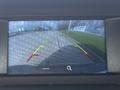 A rearview camera display showing guidelines and a clear pathway behind a 2016 Ford Transit Connect