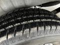 Close-up of a tire from a 2021 Mercedes-Benz Sprinter showing tread patterns and slight dirt accumulation on the surface