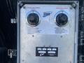 Control panel featuring dials for electric heat control and burner heat control with labels and identification information on a metal surface