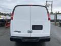 White 2014 Chevrolet Express van with a plain rear door and missing license plate holder
