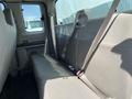 The interior of a 2008 Ford F-450 SD showing the back seat with gray upholstery and seat belts