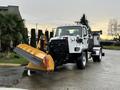 A 2016 Freightliner 108SD snow plow truck with a large yellow snow blade attached to the front