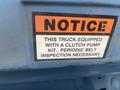 2009 Ford Econoline with a notice sticker about clutch pump kit and periodic belt inspection necessary