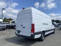 A 2025 Mercedes-Benz Sprinter van viewed from the rear with a white exterior and red taillights