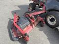 A 2014 Toro Groundmaster 5910 is shown with a red mower deck in the foreground featuring wheels and a black engine compartment