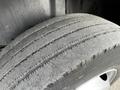 Close-up of a worn tire on a 2006 GMC C5000 showing visible tread wear and a gray surface