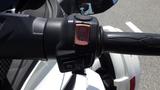 Close-up of the controls on a 2013 Can-Am Spyder featuring buttons for various functions on the handlebar