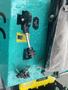 A close-up of the control panel of a 2024 AGT Industrial MH12R Mini Excavator featuring various dials switches and keys with water droplets on the surface