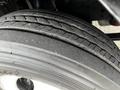 Close-up of a used tire on a 2022 Isuzu NPR showcasing visible tread patterns and slight wear on the surface