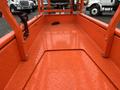 The image shows the interior of an orange JLG R1932 lift platform featuring a textured metal surface and visible mounting points