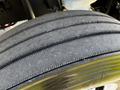 Close-up of a treaded tire from a 2016 Freightliner M2 106 showing distinct grooves and rubber texture