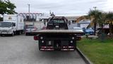 A 2008 Ford F-750 flatbed truck facing forward with a wooden platform and visible tail lights