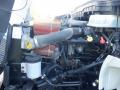 A 2014 International Durastar engine featuring various components including hoses coolant tanks and an air intake system