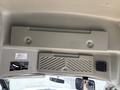 A ceiling view of a 2018 Chevrolet Express interior featuring a flat panel with bolts and a ventilation grille