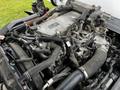 A 2018 Isuzu NRR engine with various pipes and hoses connected to it showcasing the mechanical components and structure of the engine