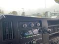 2017 Chevrolet Express dashboard featuring climate control dials and a radio display with various buttons and knobs