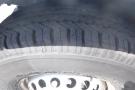 Close-up of a tire from a 2012 Mercedes-Benz Sprinter showing detailed tread patterns and the wheel rim design
