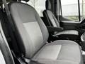 Two gray seats of a 2021 Ford Transit van featuring fabric upholstery with a textured pattern