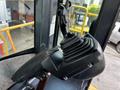 A close-up view of the joystick control inside a 2006 John Deere 470G heavy equipment operator's cabin