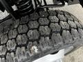Close-up of a worn tire tread on a 2008 Ford F-450 SD showing a hexagonal pattern with visible dirt and wear on the rubber surface
