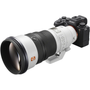 Sony FE 300mm f28 GM OSS Lens attached to a camera body featuring a black and silver design with a prominent lens hood and focus control markings