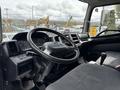 Interior view of a 2017 Hino 338 showing the steering wheel dashboard and gear shift with seats in the foreground