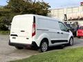 A white 2019 Ford Transit Connect van is parked with a plain rear view showcasing its sleek design and logo on the back door