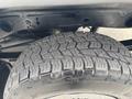 Close-up of a tire from a 2016 GMC Sierra 1500 showing detailed tread pattern and sidewall markings
