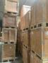 Stacked wooden crates made of untreated wood featuring metal corner protectors and labeling for contents and sizes