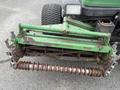 A 2009 John Deere 2653B Precision turf maintenance machine with a green frame and rusty metal components including a cylindrical roller at the front
