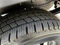 Close-up of a tire tread on a 2015 Ford Transit showcasing deep grooves and a rugged design for enhanced traction