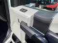Interior door handle of a 2019 Ford F-550 with a textured panel and chrome accents