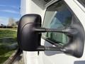 Close-up of the side mirror of a 2012 Ford Econoline E-450 with a black housing and two support arms