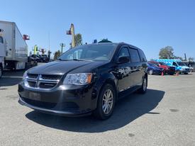 A black 2020 Dodge Grand Caravan parked with a smooth body design and five-spoke wheels